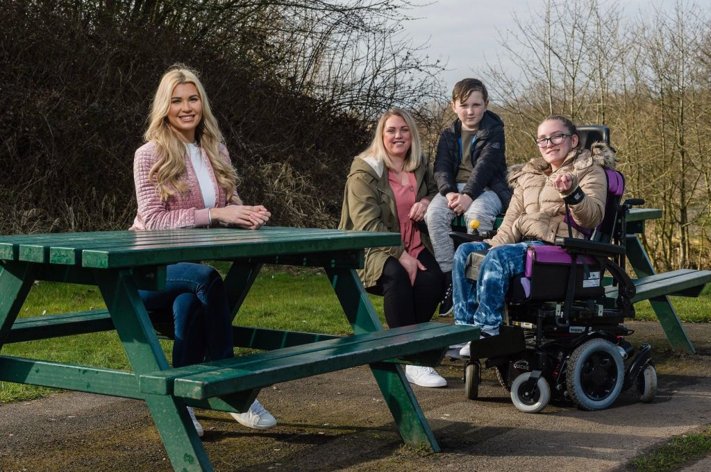 Christine McGuinness and family outside on picnic bench.