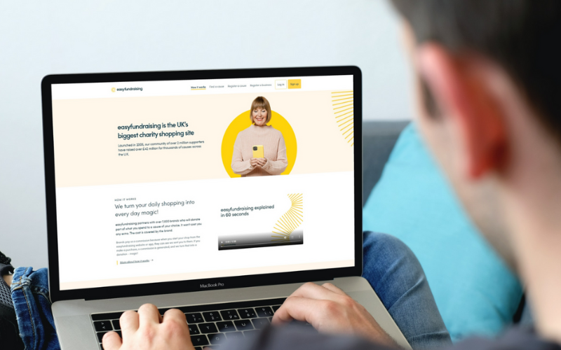 A man on a laptop shopping through easyfundraising on the screen