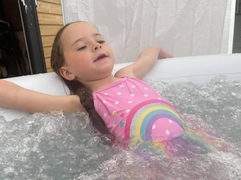 Cleo, aged six, relaxing in her hot tub.
