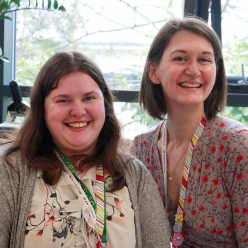 Two ladies smiling wearing Family Fund lanyards