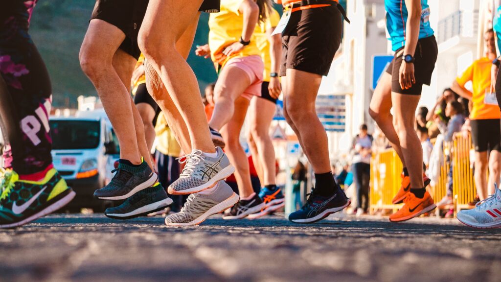 Shot from low down, showing a group of runners legs preparing to start a race