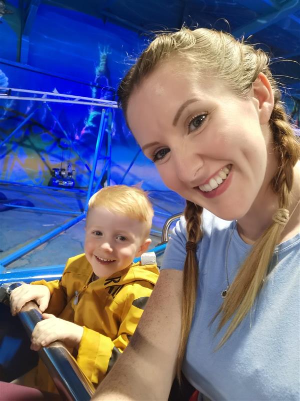 Mum and little boy take a selfie on a ride