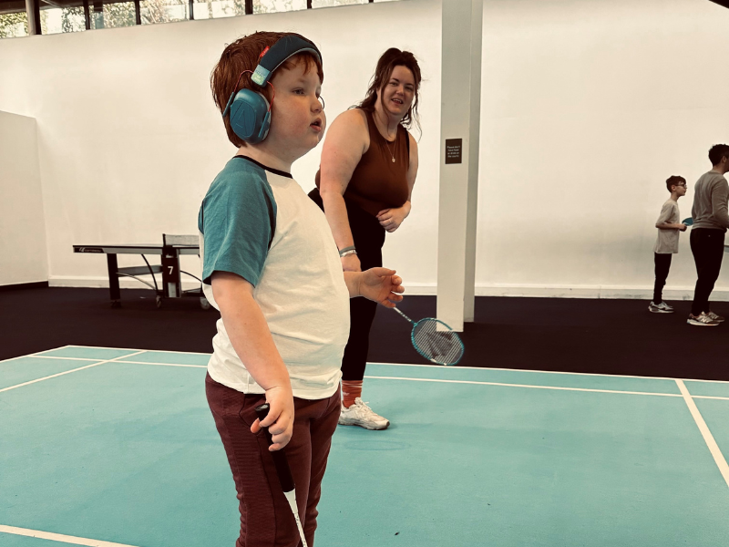 Olly, aged 5, wears ear defenders as he plays badminton with his mum, Lily.