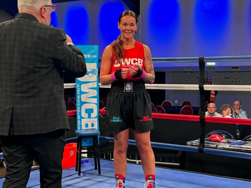 Donna wearing her red top and personalised shorts, featuring Ryan and Adam's names.