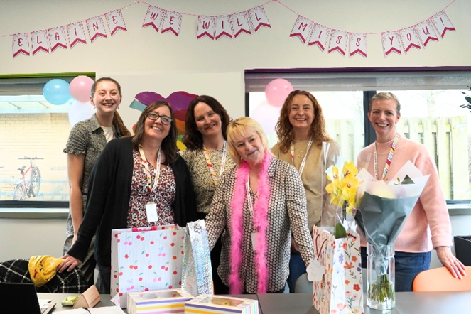 Elaine pictured with the Information and Support team, all smiling together in a group photo.