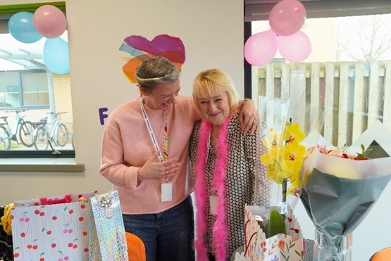 Elaine and a colleague sharing a warm laugh together at a Family Fund gathering.