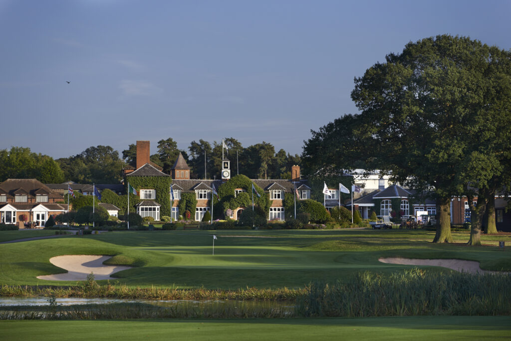 Photo of The Belfry manor house in the background with a golfing green with two sand bunkers either side of it in the foreground.
