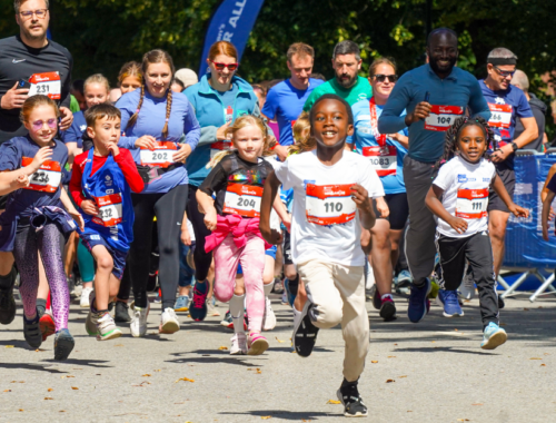 A group of children and adults participate in the York Mini race.