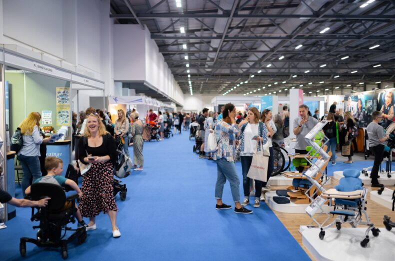 A group of people wandering around the Kidz to Adultz exhibition hall
