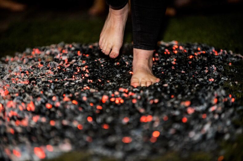 Someone walking barefoot across hot coals