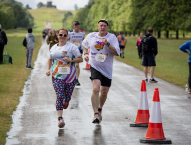 Two people running in Family Fund t-shirts