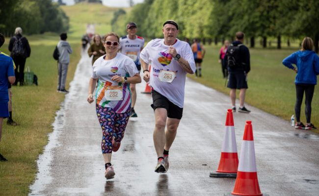 Two people running in Family Fund t-shirts