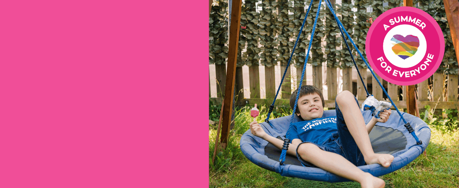 A young boy sat on a swing with a circular stamp in the corner with a heart in the middle, surrounded by the text 'A summer for everyone.'