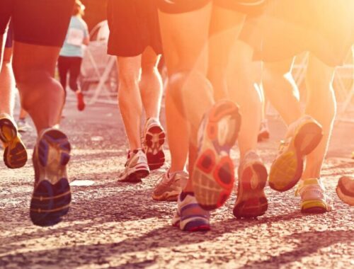 A lot of peoples legs in running trainers during an event