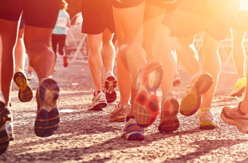 A lot of peoples legs in running trainers during an event
