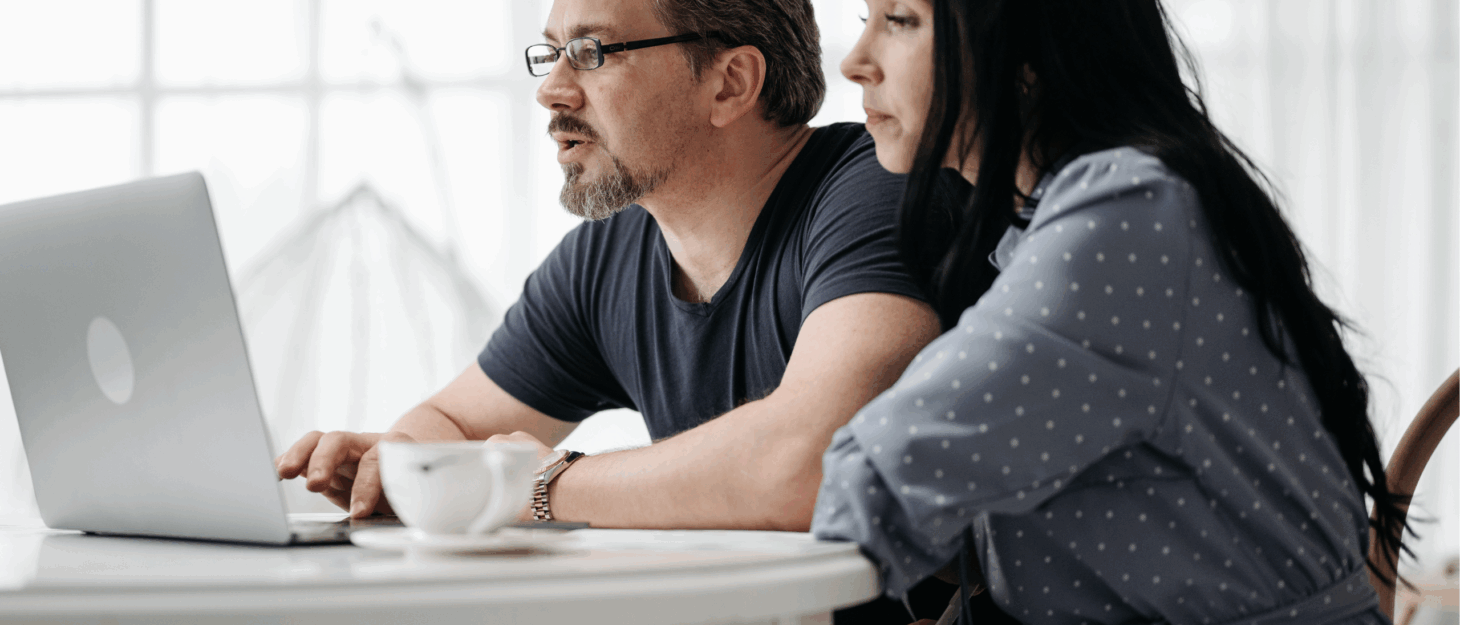 A couple sitting together looking at a computer
