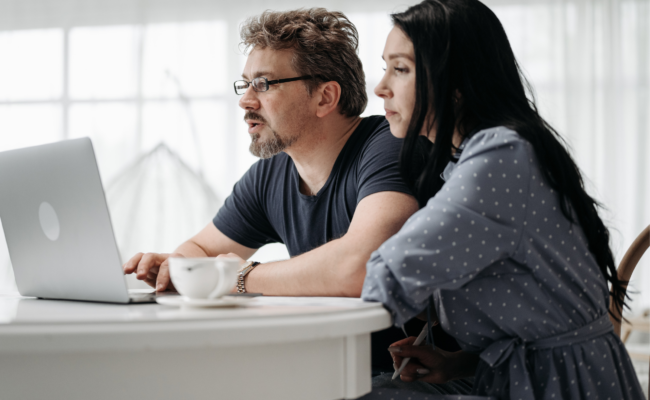 A couple sitting together looking at a computer