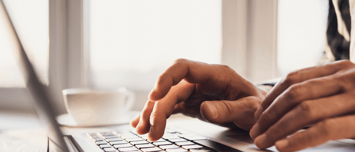 A close up of a hand typing on a keyboard