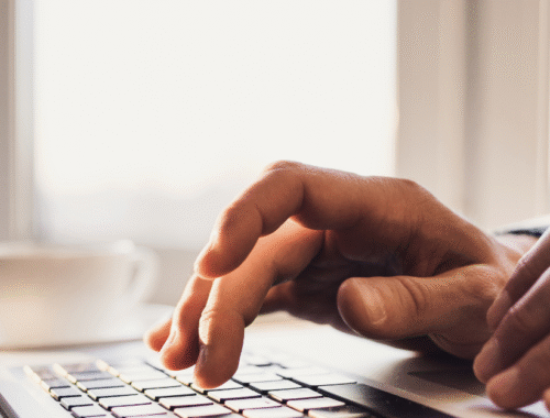 A close up of a hand typing on a keyboard