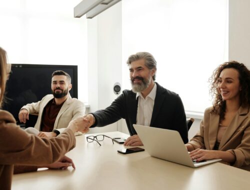 board members shake hands