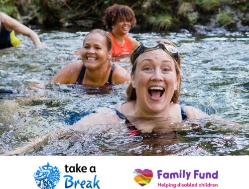 A group of women are cold water swimming in a river. A white banner at the bottom of the image shows the Take a Break Scotland and Family Fund logos.