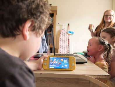 A young family play together on various devices.