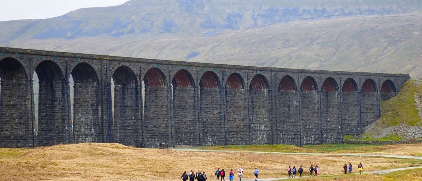 Part of the Yorkshire Three Peaks route with walkers heading towards the Ribblehead Viaduct