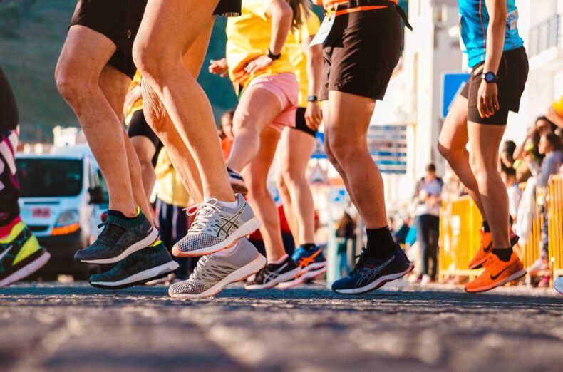 Shot from low down, showing a group of runners legs preparing to start a race