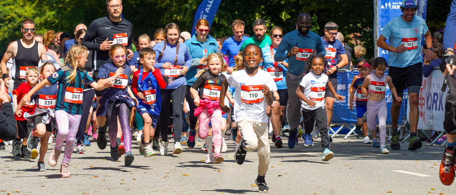 A group of children and adults participate in the York Mini race.
