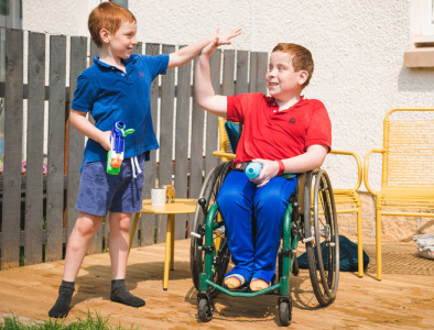 two siblings playing together and doing a high five