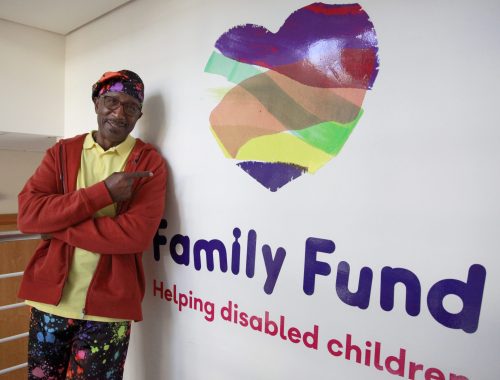 Mr Motivator in the Family Fund office, pointing at our Family Fund logo