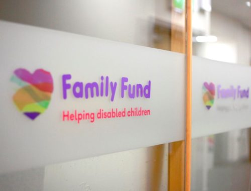 The Family Fund logo on a frosted glass window inside an office