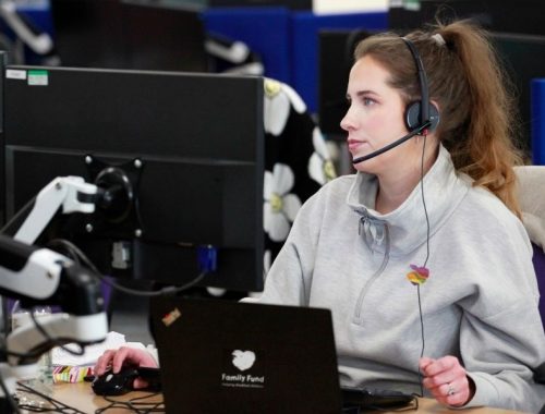 a family fund contact officer on the phone with a family looking at her screen