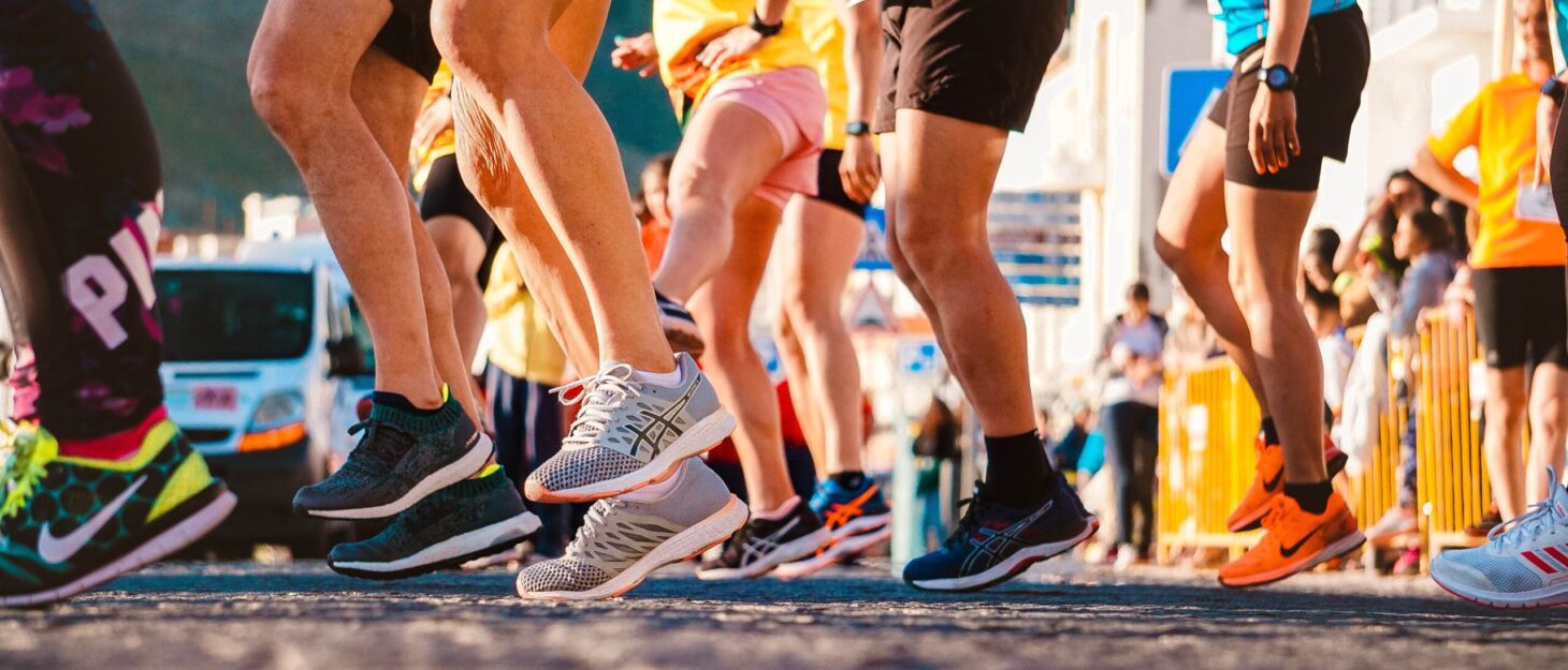 Shot from low down, showing a group of runners legs preparing to start a race