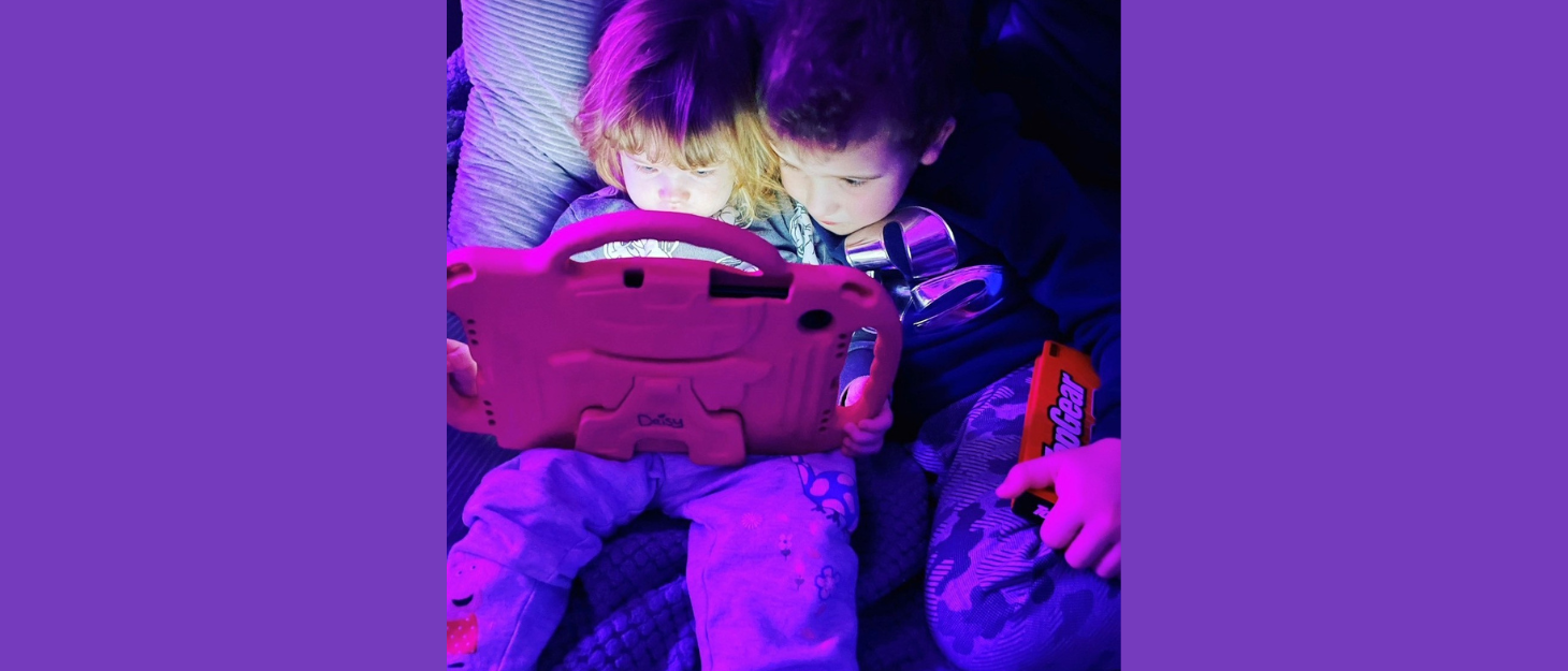 Jake and his sister, Daisy, looking at the iPad