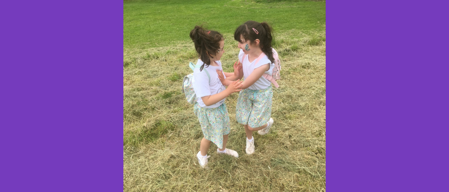 Laura and Ruby in the park wearing matching clothes as they play with each other.