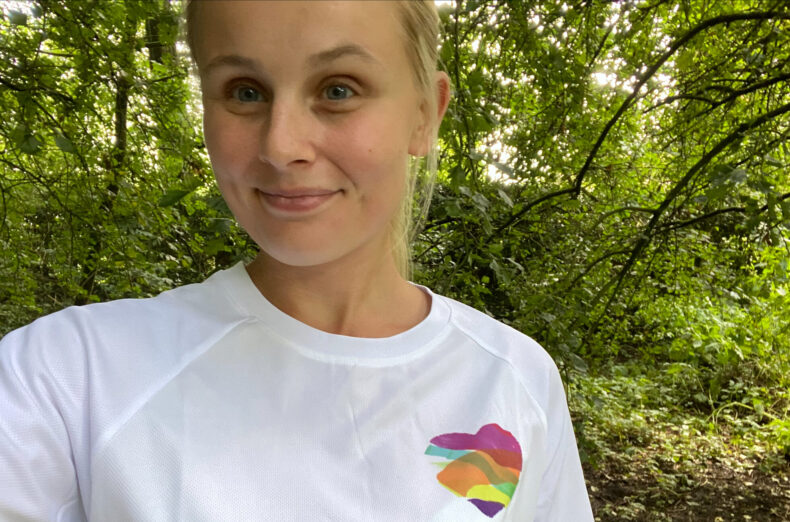 Woman wearing a white Family Fund t-shirt